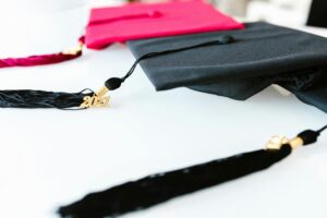 Graduation caps with tassels marked 2021, symbolizing academic achievement.