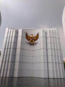 Image of the Garuda Pancasila emblem on a modern architectural wall in Bandung, Indonesia.