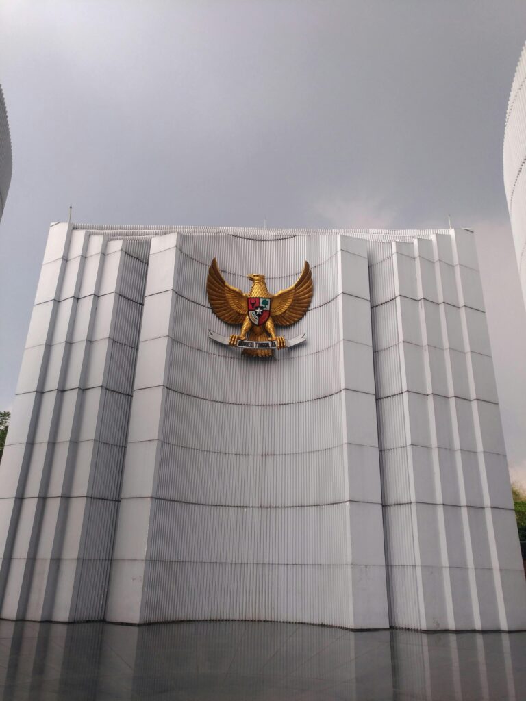 Image of the Garuda Pancasila emblem on a modern architectural wall in Bandung, Indonesia.